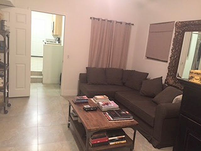 Bedroom/living room. 2 windows in picture. This couch makes into a bed where the tenant sleeps