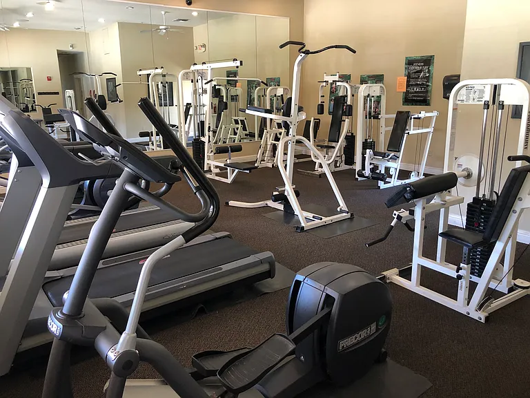 Resident private gym overlooking pool area with bathrooms.