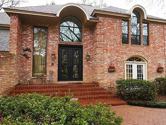 With amazing curb appeal, this estate home welcomes you with a grand entrance. The notable hand-forged custom  wrought iron doors are exceptional. Lush landscaping and brick paths add old world charm and character to the property.