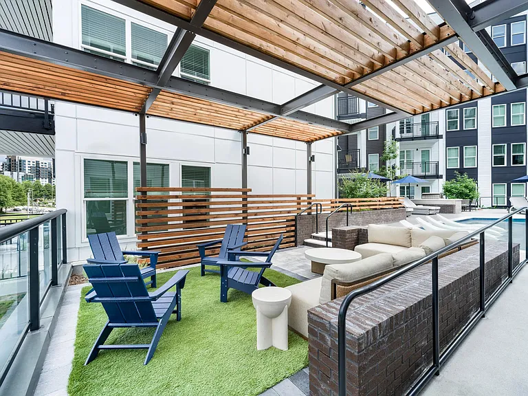 Pergola-covered terrace with lounge seating, Adirondack chairs, and open-air gathering areas designed for relaxed afternoons in Atlanta.