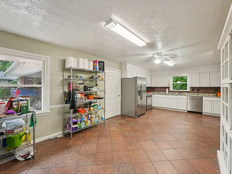 This practical yet inviting storage space blends convenience and character, with tiled floors, built in cabinetry, and room for life's little essentials.