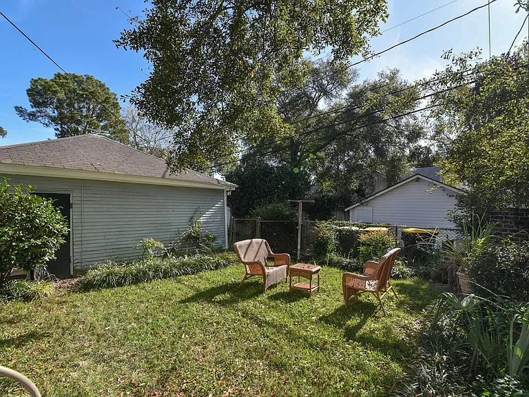 Fenced garden with view of the garage.