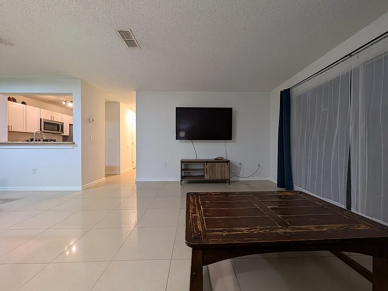 Living room, hallway and kitchen in view