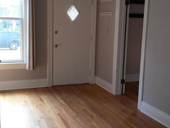 From the middle room (dining) to front door. Shows door to front bedroom.