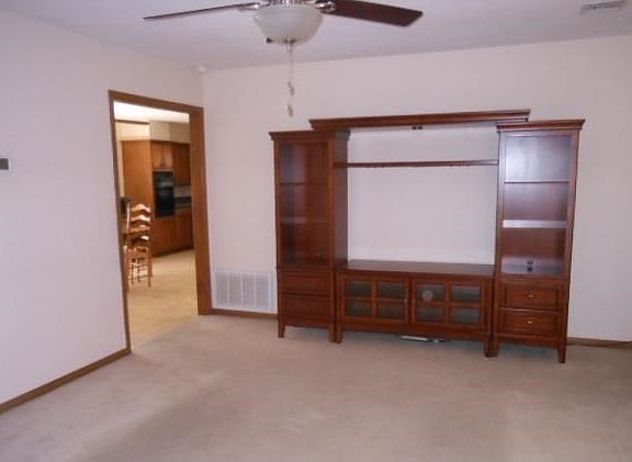 Roomy living room with ceiling fan