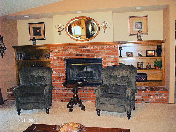 brick fireplace & bookshelves in familyroom