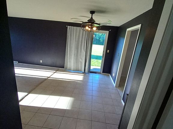 Dining room w/ sliding glass door to side yard.