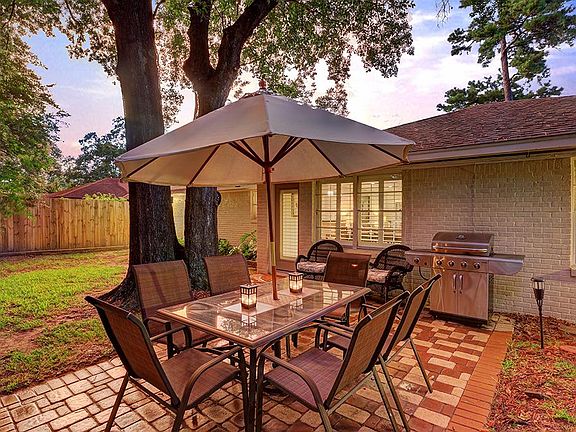 Backyard oasis with a spacious amount of green space and patio.