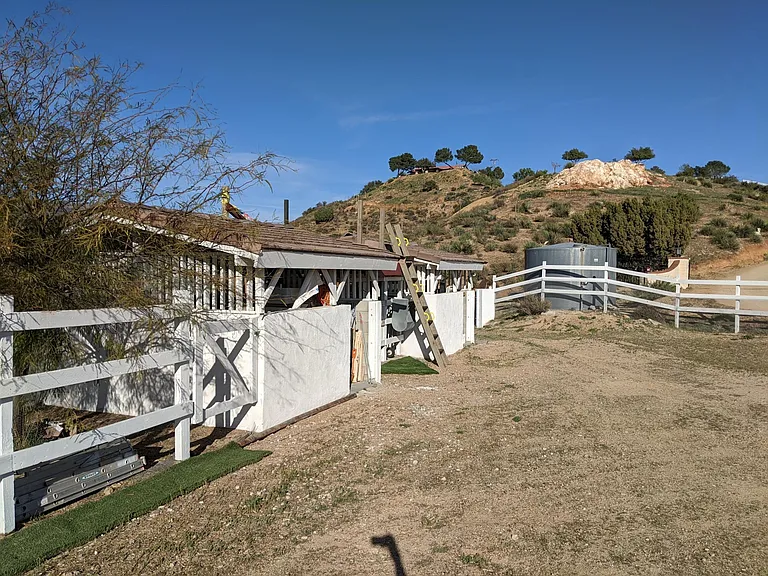Horse stalls (now storage) and paddock. Historic rose quartz monument on adjacent property.