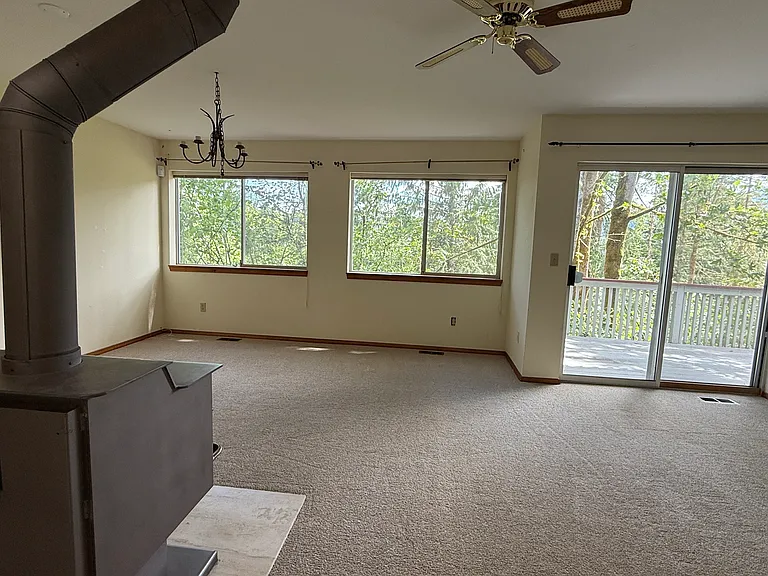 Spacious downstairs living room with brand-new carpet.