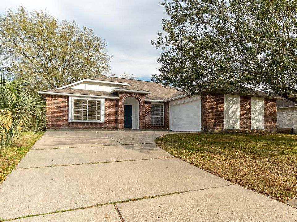 Pretty brick one story has welcoming front porch and plenty of parking space.