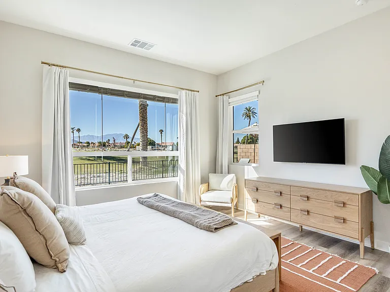 The master suite has amazing views to the outdoor space and golf course view!