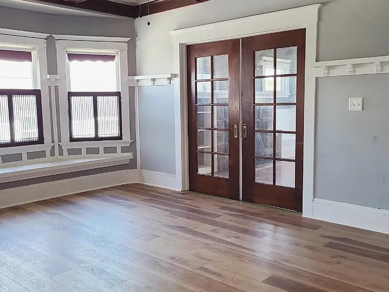 Wood work detailing, bench window seat with storage underneath. Double pocket doors leading to formal living room from this large dining space (can be used as family room as well).