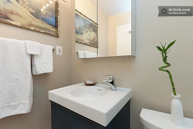 Crushed marble sink, rear-lighted medicine cabinet.