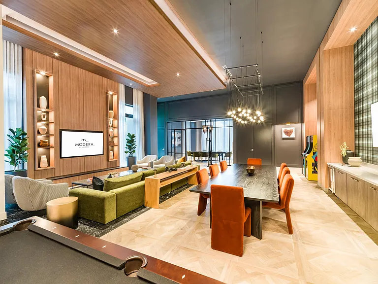 Layered seating, warm wood details, and integrated screens create a media room designed for group viewing, casual gatherings, and relaxed entertainment.