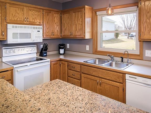 New coordinating stainless pendant and cabinet hardware look great with the fresh gray paint.