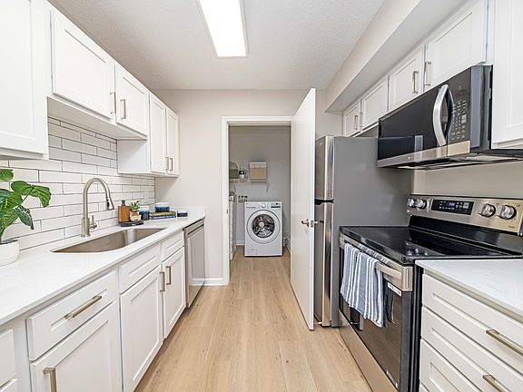 Kitchen with granite counters, modern cabinetry, and stainless steel appliances