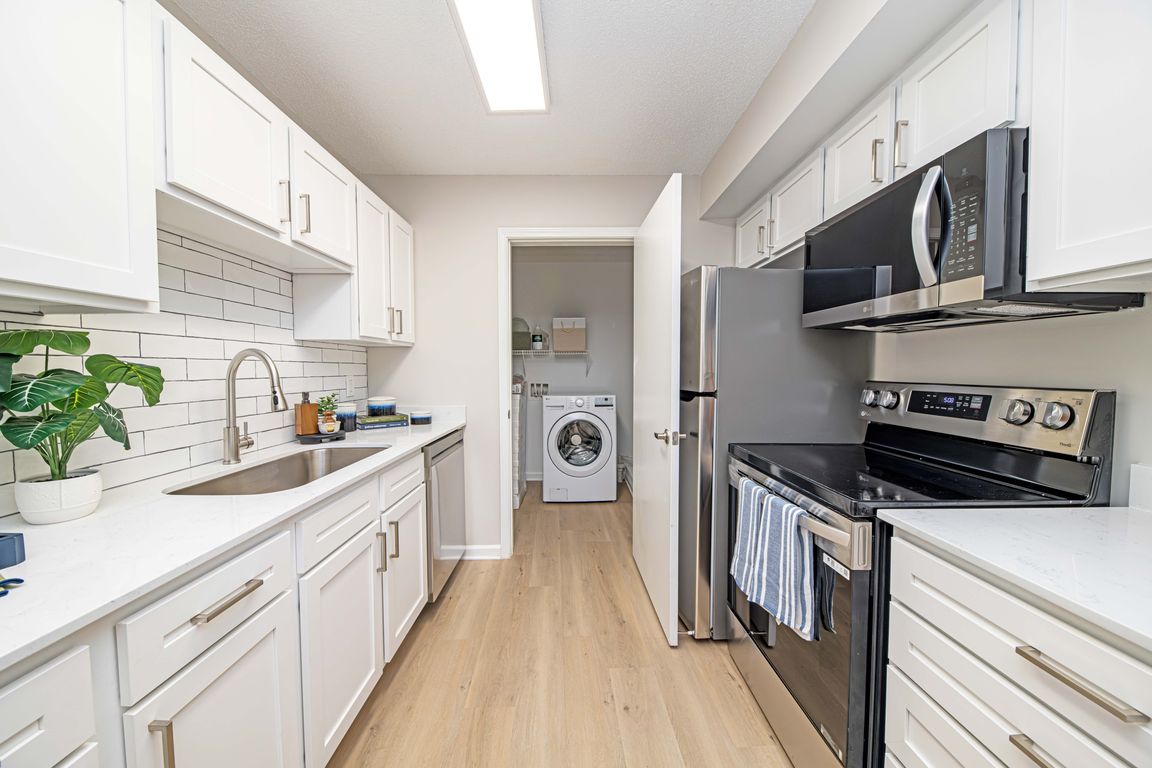 Kitchen with granite counters, modern cabinetry, and stainless steel appliances