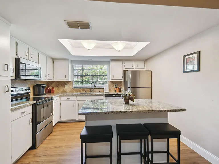 Totally updated kitchen with granite counter tops, tiled back splash and brand new stainless steal appliance