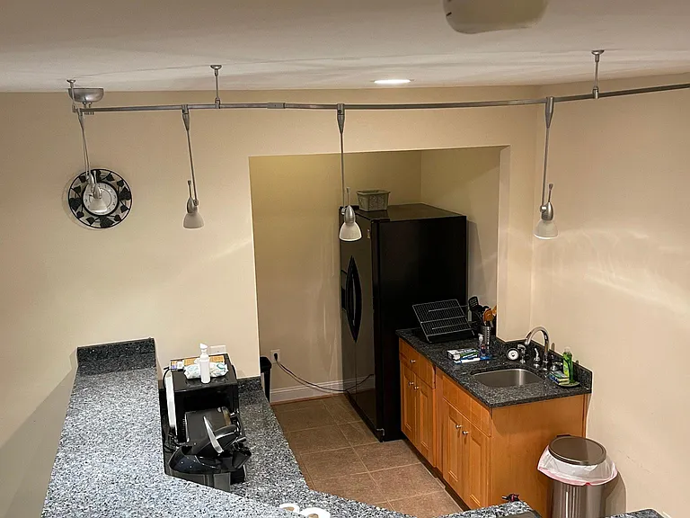 Private kitchenette equipped with: microwave, electric stove, toaster, and large fridge.
