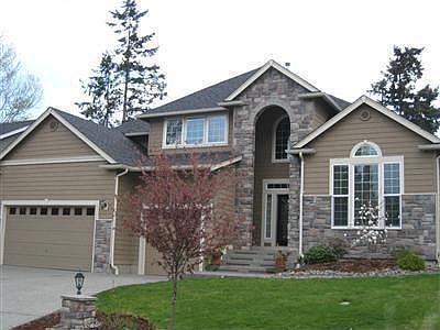 Craftsman details with contemporary function, cement siding with stone detailing