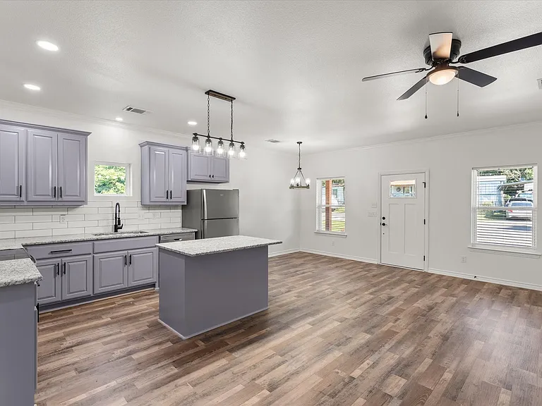 Open-concept living area with wood-finish flooring