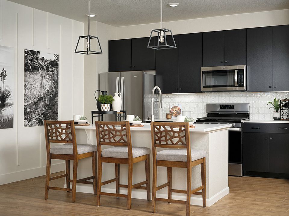 Explore culinary endeavors in a gourmet kitchen elevated by white quartz counters, decorative backsp