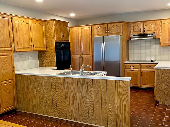 Kitchen boasts new stainless steel refrigerator and dishwasher. Electric stove and wall oven.