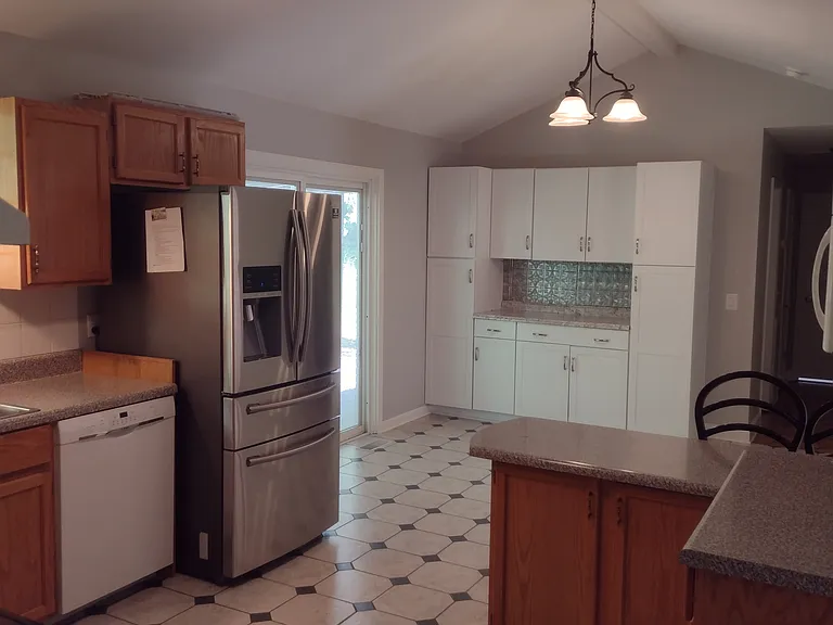 Dining and kitchen with breakfast bar seating