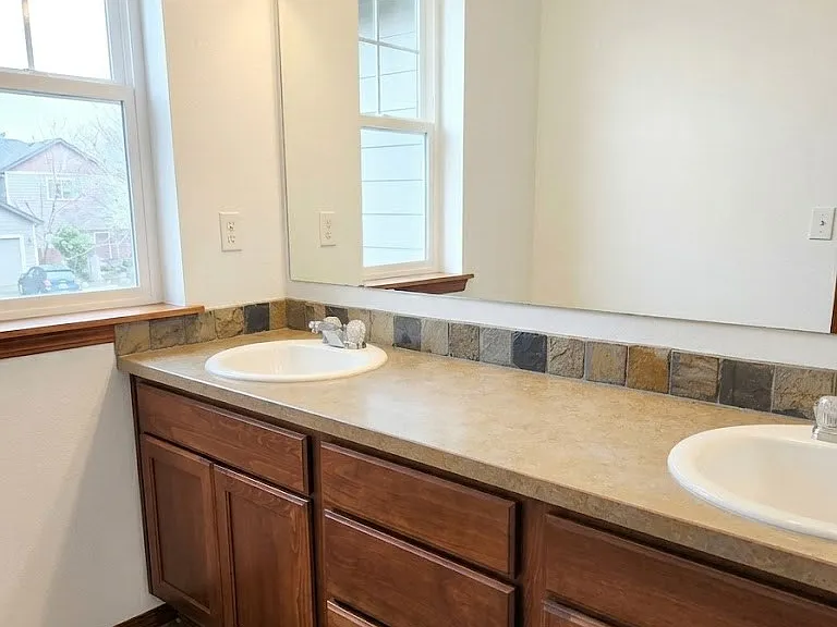 Spacious primary bathroom with dual sinks.