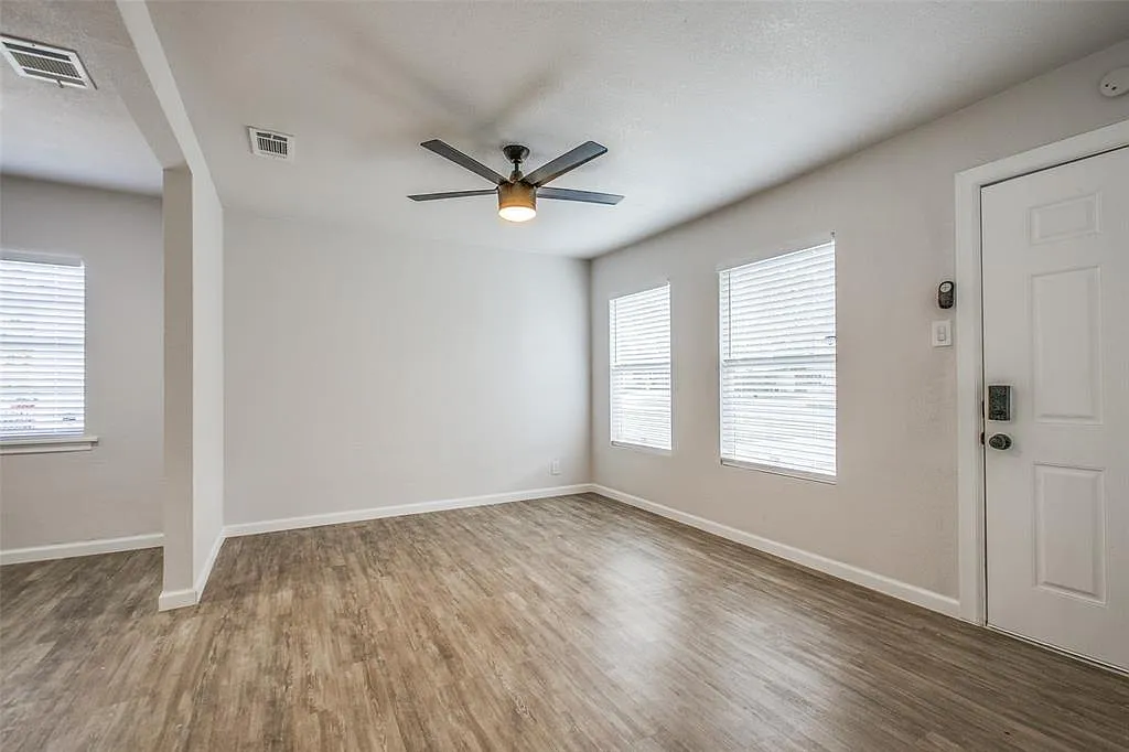 Spare room featuring wood finished floors, a ceiling fan, and healthy amount of natural light - 637 N 4th St