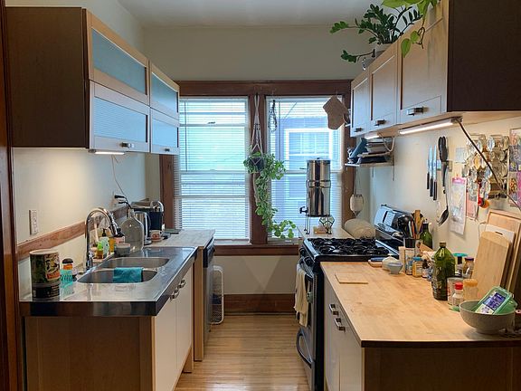Kitchen - dishwasher, lots of cabinet space, butcherblock countertops, stainless steel double basin sink and countertop, and gas range.