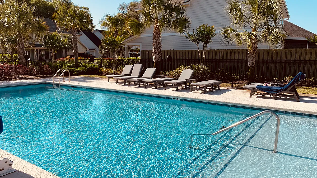 Pool area with seating and palm trees - 28 Tabby Place Ln