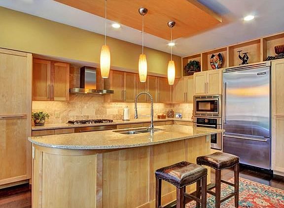 Modern, gourmet kitchen features 5 burner gas cooktop, built-in oven and microwave, custom Viking fridge and warming drawer.