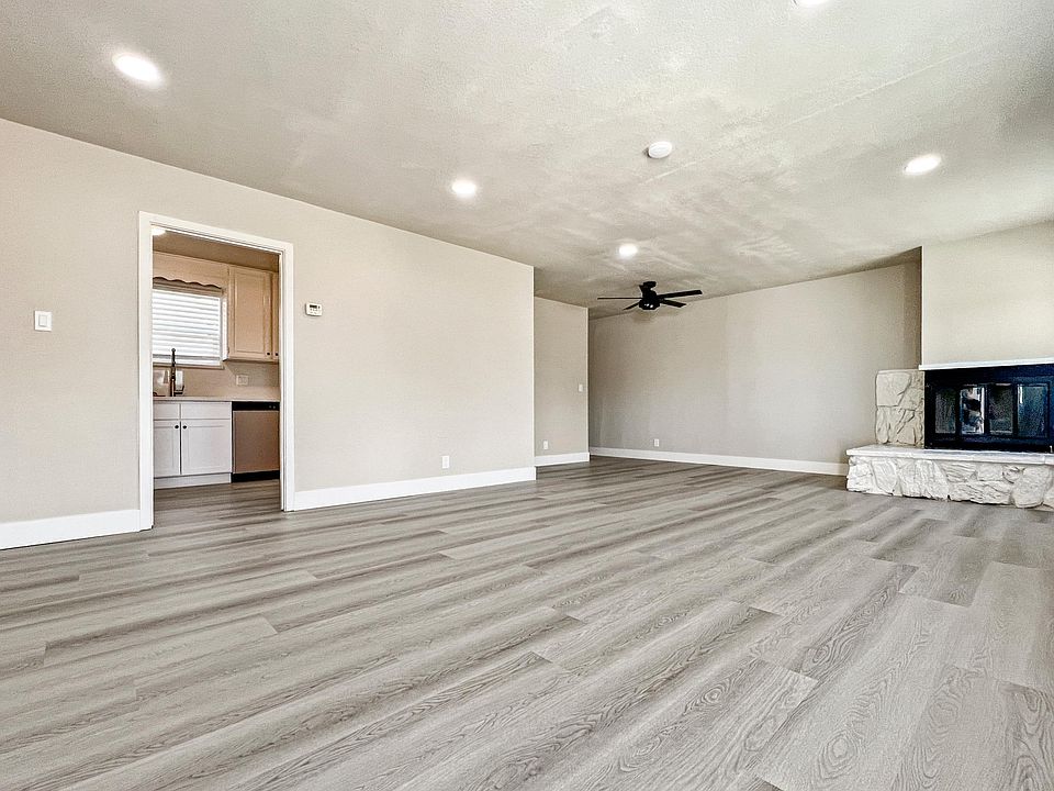 Large living room with recessed lights & decorative fireplace