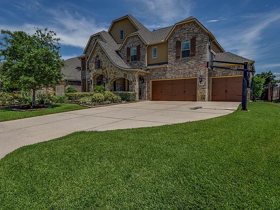 Beautiful stacked stone front elevation, triple wide driveway leads to the 3 car garage which has an epoxy floor.