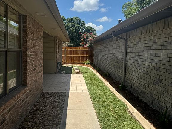 Yard with patio entry to living room. Privacy fence