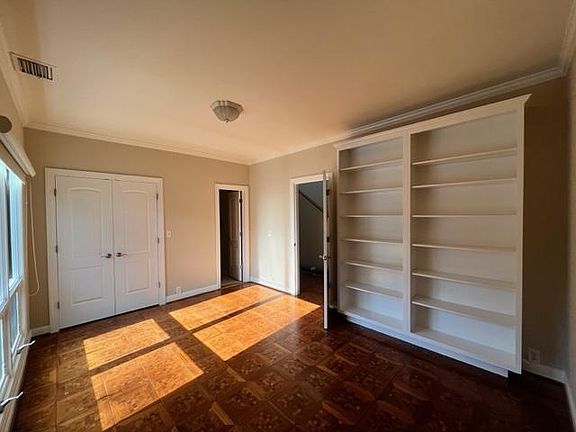 Downstairs bedroom with bath, closet and shelving