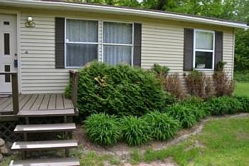 The home has landscaping already established.  It wraps all the way around the home.