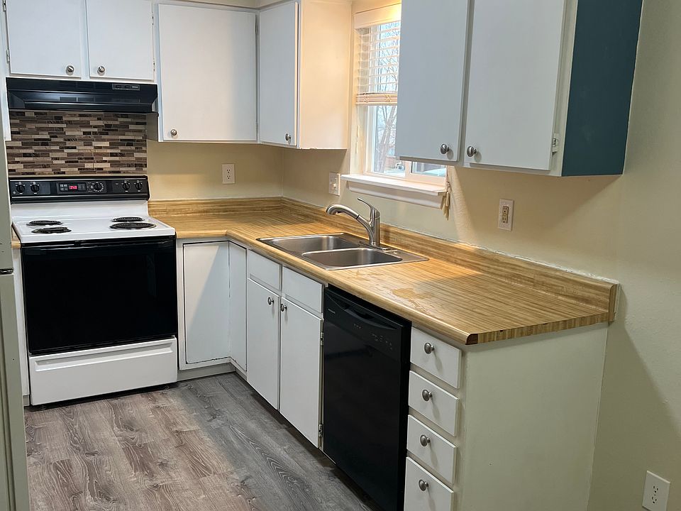 Kitchen with brand new luxury vinyl flooring, dishwasher, electric range , LED lights and loads of cabinets