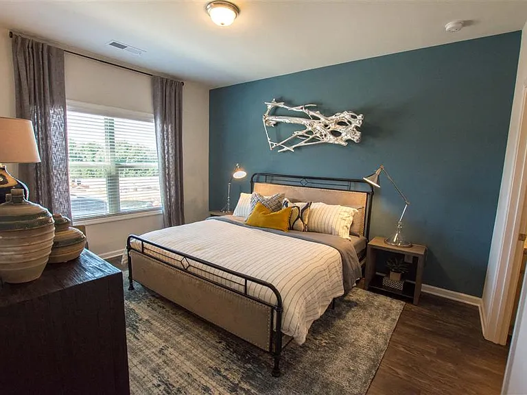 Primary bedroom with king size bed and large window.