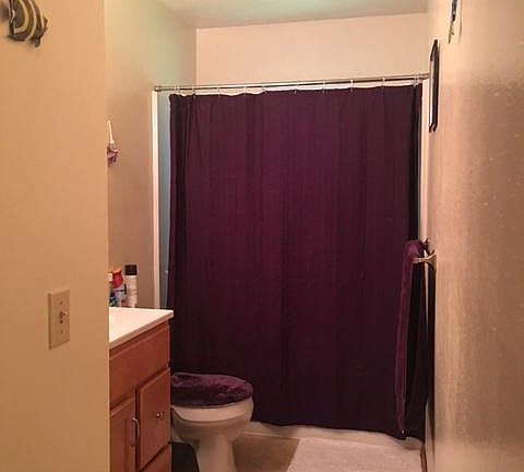 This big bath room features a tub and shower.