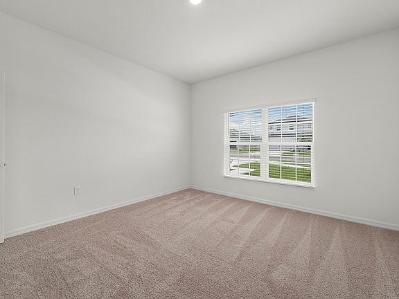 Spacious master bedroom with a large window