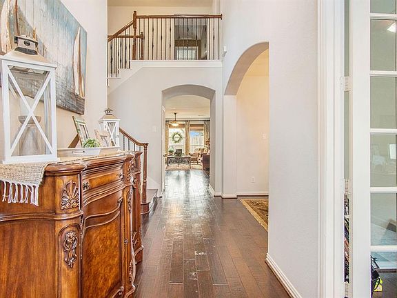 Grande two story foryer with wood floors and fresh paint.