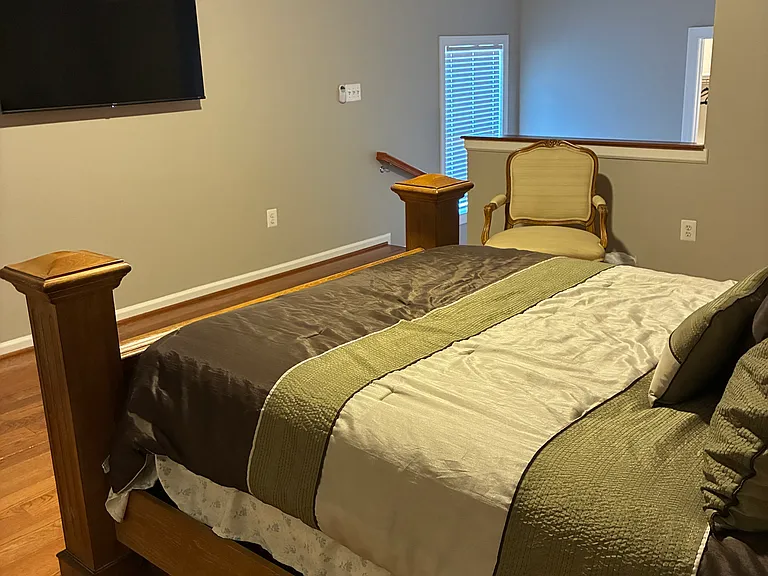 Master Bedroom 1, TV and sitting chair.