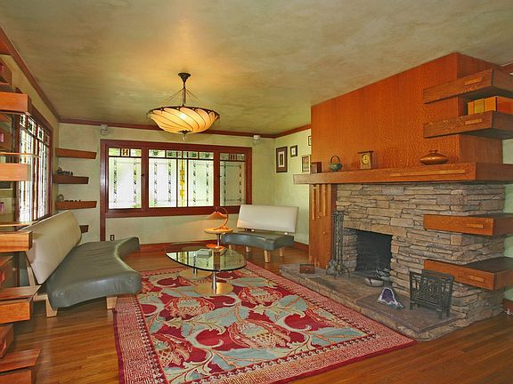 living room with fireplace and custom woodwork
