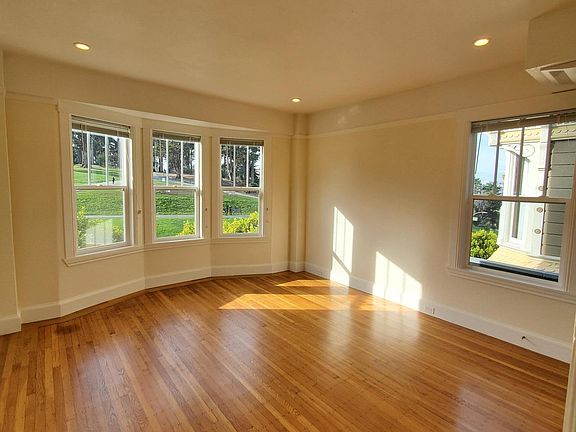 PICTURESQUE LIVING ROOM WINDOWS WITH VIEW OF THE PARK