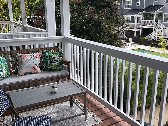 Large porch overlooking community pool and gym