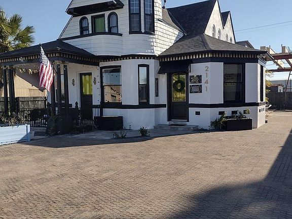 Exterior of house with front door to main house on right. Foyer just inside. D is upstairs.