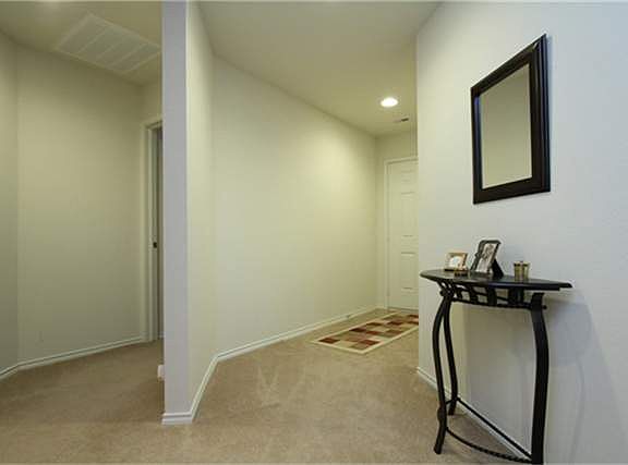  THE ENTRY HALL OFFERS CERAMIC TILE FLOOR & A PRIVATE INTRODUCTION TO AN OPEN FLOOR PLAN THRU THE EXTENDED ENTRY. A SHORT FRONT HALLWAY LEADS TO THE SECONDARY BEDROOMS & A LARGE HALL BATH.
